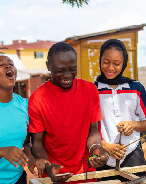 Group of Africans feeling excited about what they saw on their cellphone A group of Africans feeling excited about what they saw on their cellphone